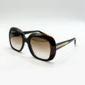 Lunettes de soleil Emmanuelle Khanh foncées oversize avec détails dorés