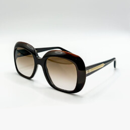 Lunettes de soleil Emmanuelle Khanh foncées oversize avec détails dorés